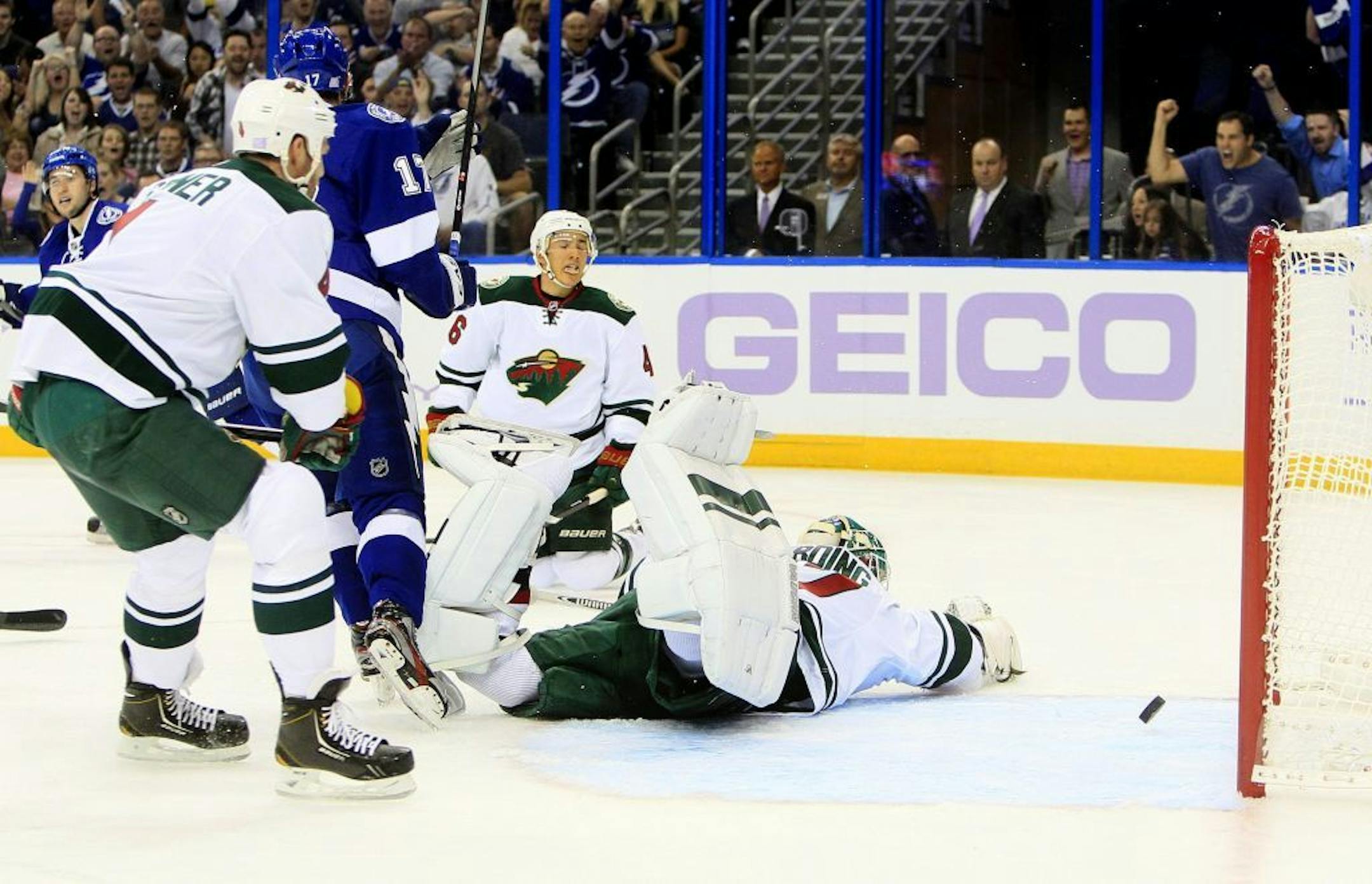 The Tampa Bay Lightning's Tyler Johnson, far left, puts the puck past Minnesota Wild goalie Josh Harding in the first period at the Tampa Bay Times Forum in Tampa, Florida, on Thursday, October 17, 2013. The Lightning won, 3-1.