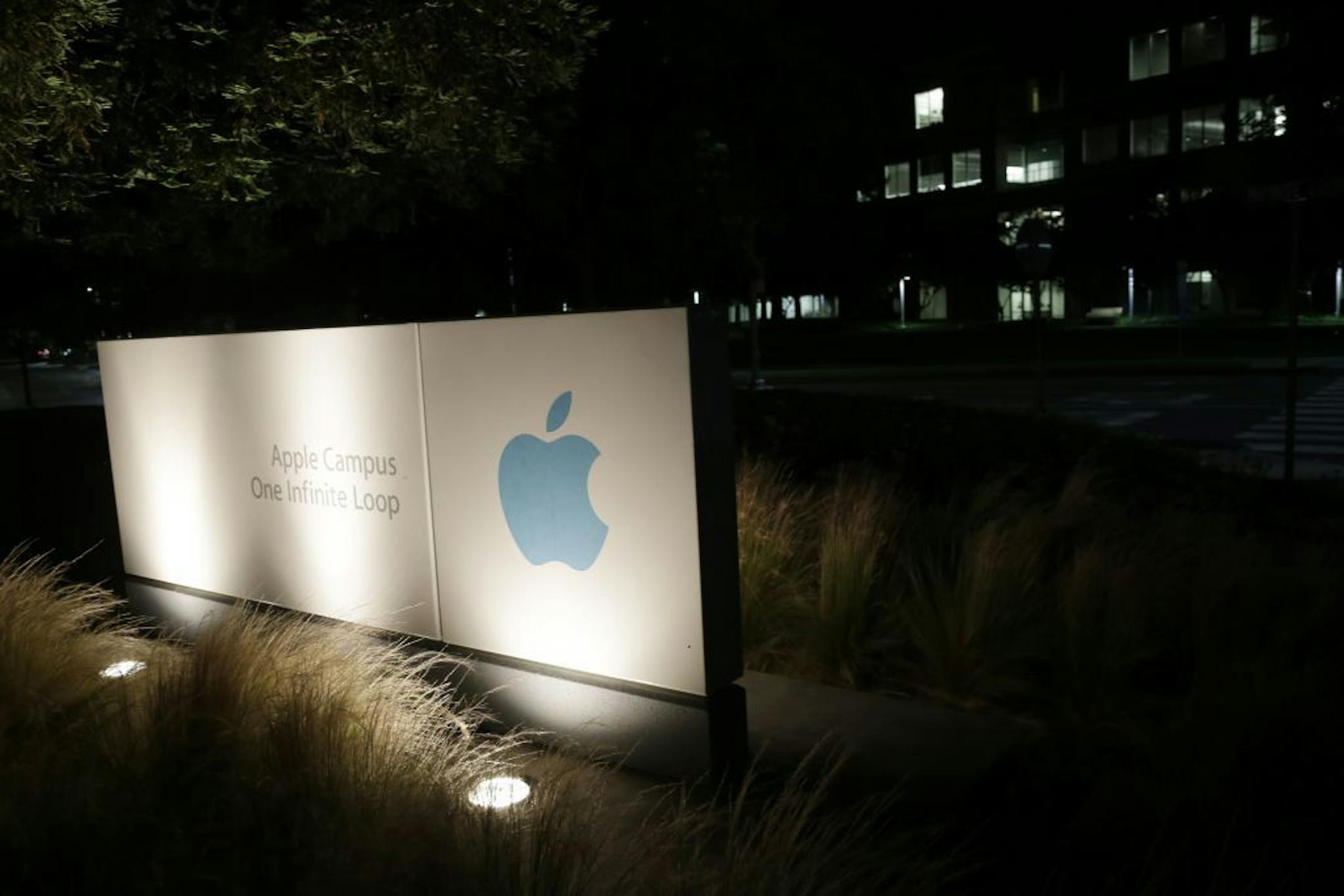 FILE - In a Friday, June 7, 2013 file photo, a sign displays the Apple logo outside of the company's headquarters in Cupertino, Calif. A federal judge ruled Wednesday, July 10, 2013 that Apple Inc. broke antitrust laws and conspired with publishers to raise electronic book prices, citing "compelling evidence" from the words of the late Steve Jobs. U.S. District Judge Denise Cote said Apple knew that no publisher could risk acting alone to try to eliminate Amazon.com's $9.99 price for the most po