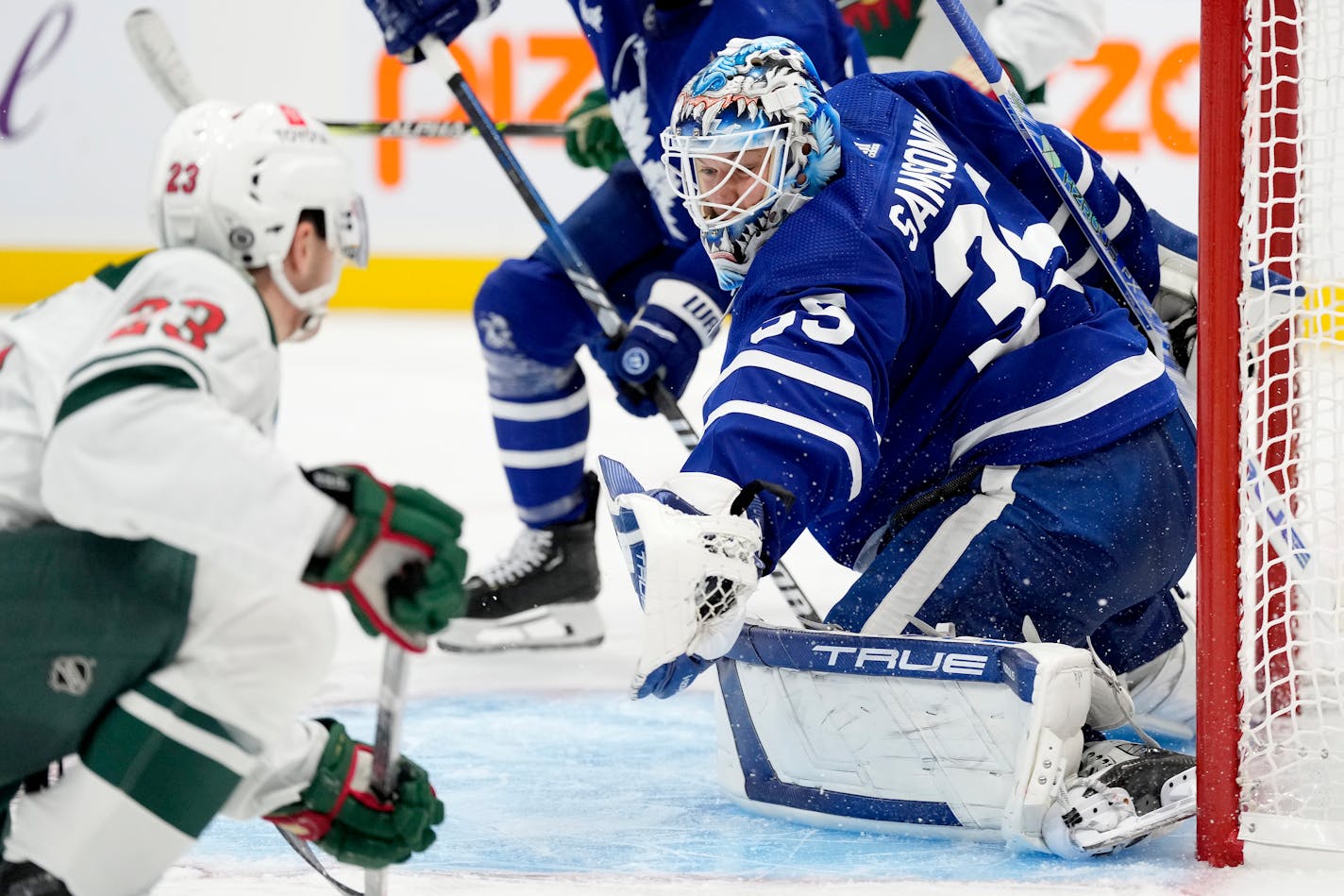 Toronto Maple Leafs goaltender Ilya Samsonov (35) makes a save against Minnesota Wild center Marco Rossi (23) during the third period of an NHL hockey game in Toronto, Saturday, Oct. 14, 2023. (Frank Gunn/The Canadian Press via AP)