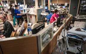 Because of the shortage of beds, patients are placed and seen in the hallways of the emergency department in Maplewood, Minn., on Thursday, Nov. 3, 20