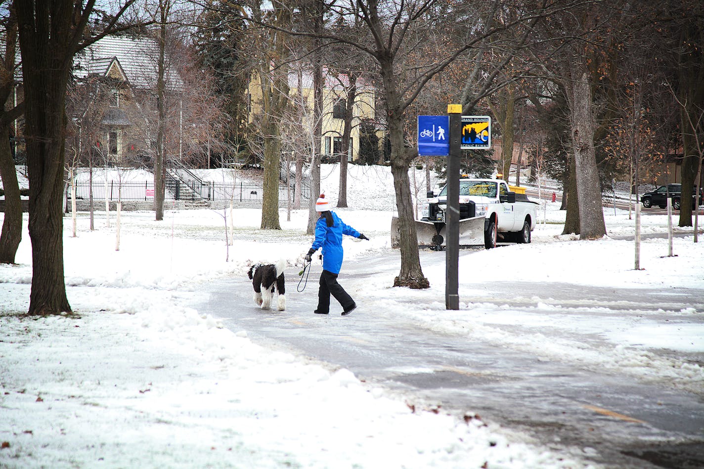 A pedestrian walks on the newly cleared walking path near Dean Parkway and 28th St. in south Minneapolis early Friday.