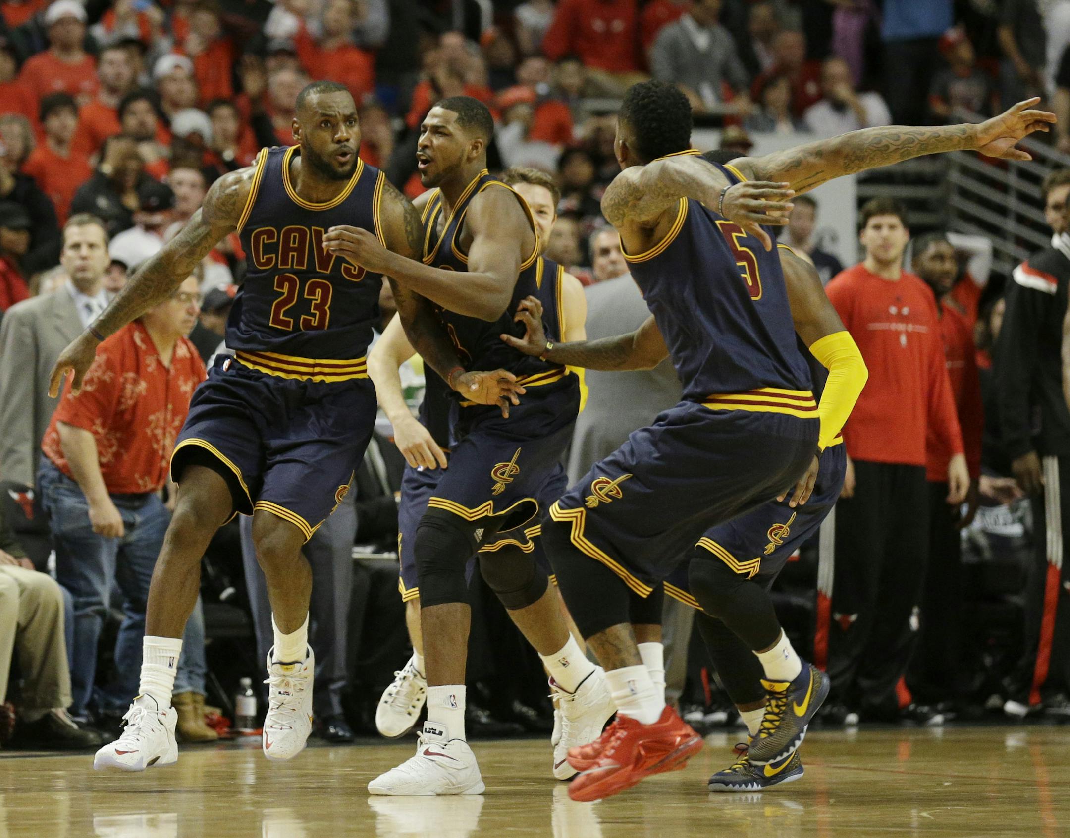 Cleveland Cavaliers' LeBron James, left, celebrates with Tristan Thompson, center and J.R. Smith after scoring the game-winning basket during the second half of Game 4 in a second-round NBA basketball playoff series against the Chicago Bulls in Chicago on Sunday, May 10, 2015. The Cavaliers won 86-84. (AP Photo/Nam Y. Huh)