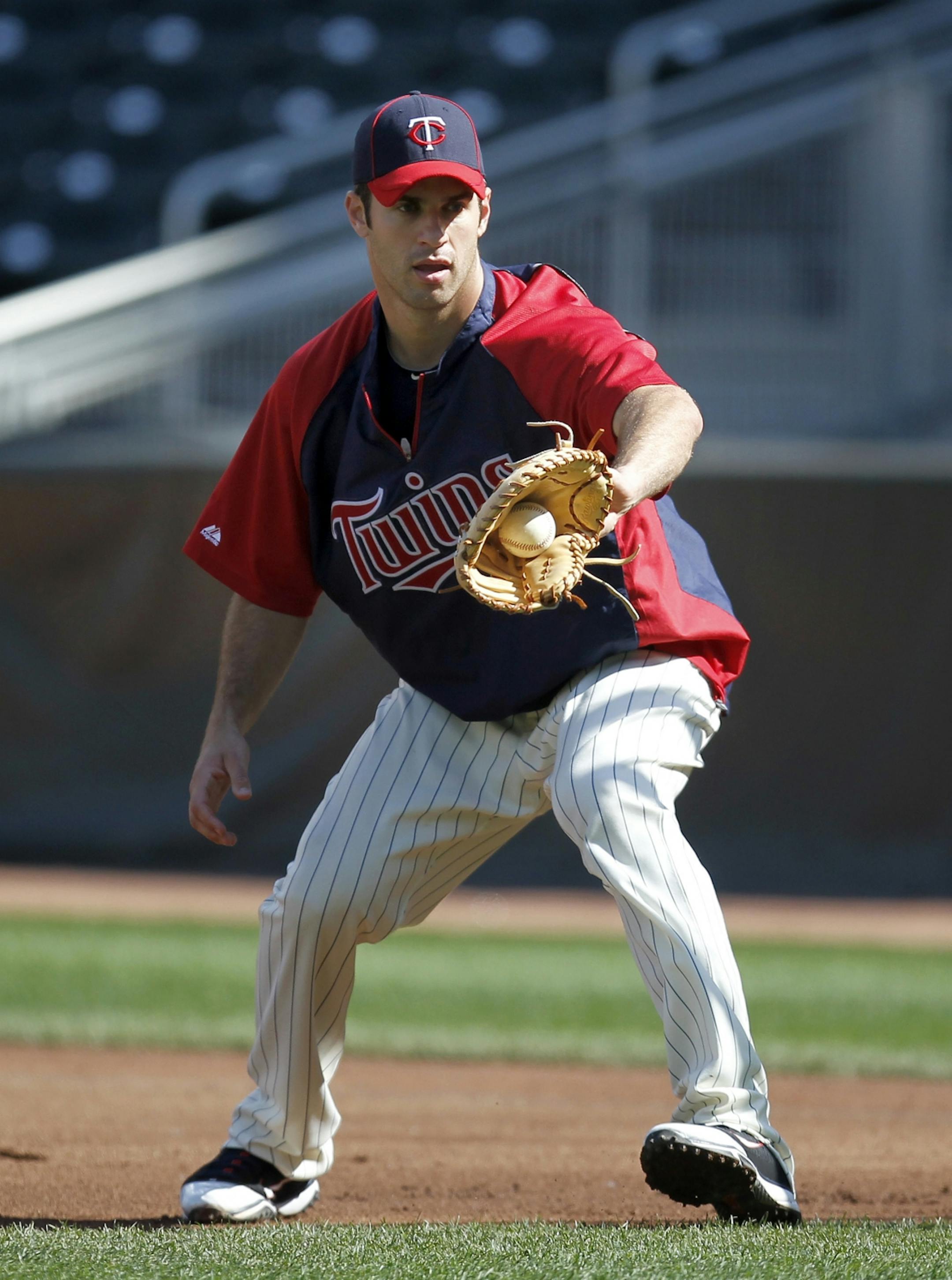 Joe Mauer took grounders at first base during batting practice on June 27.