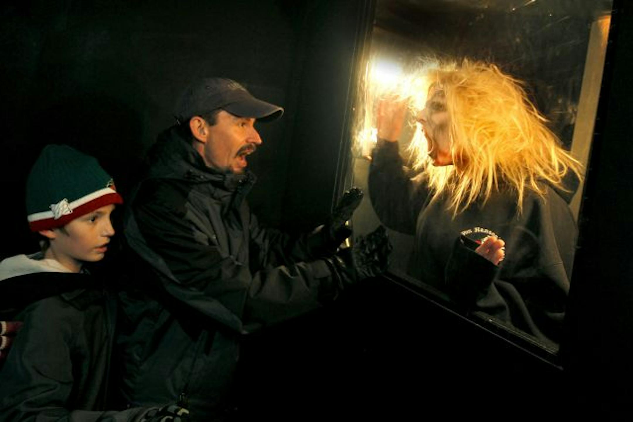 Taking the kids through the halls of a haunted house at Zywiec�s Gardens can get you scared too. Tom Killeen with one of his kids Taylor.