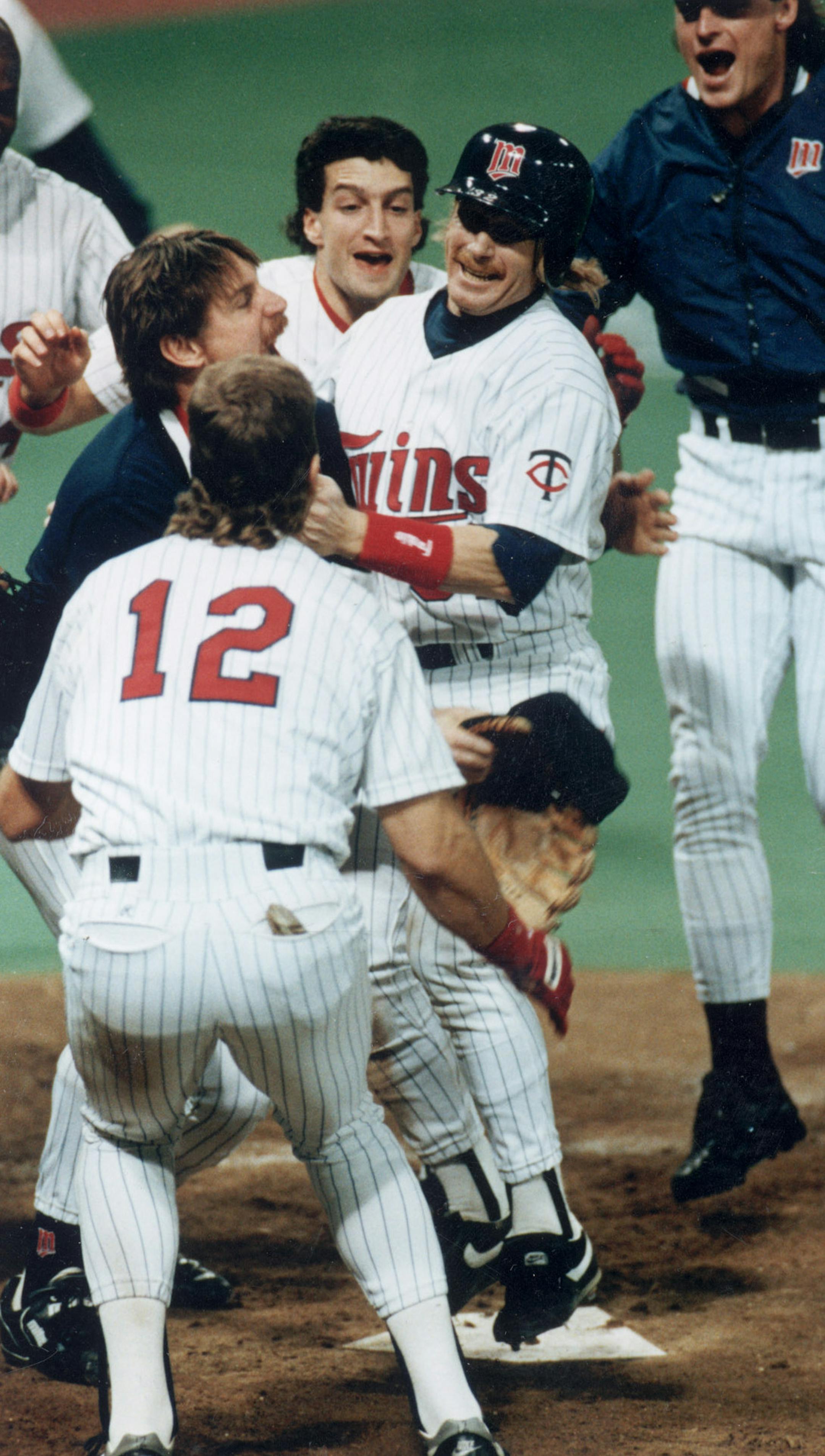 Sunday October 27, 1991 -- Dan Gladden (center, wearing helmet) scores the only run of the game in the Minnesota Twins 1-0 victory over the Atlanta Braves in Game 7 of the 1991 World Series. Star Tribune photo by staff photographer Jeff Wheeler. ORG XMIT: MIN2014102411222036 ORG XMIT: MIN1905271741330607 ORG XMIT: MIN2004291827040204