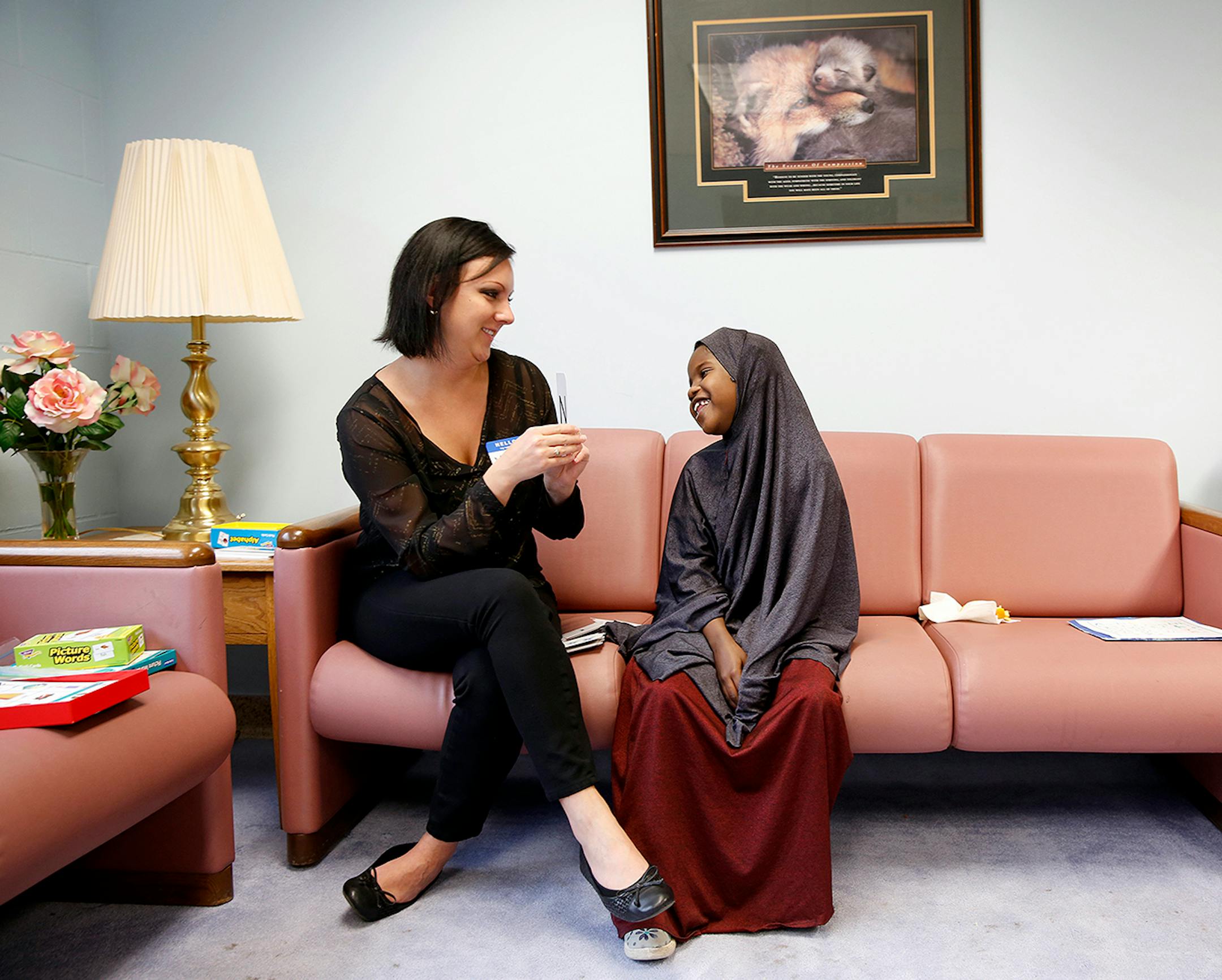 Somali immigrant Ugbad Shukri, 7, works with tutor Melissa Latterell to learn to read, write and speak English at Mary's Place transitional apartments in downtown Minneapolis. ] LEILA NAVIDI leila.navidi@startribune.com / BACKGROUND INFORMATION: Tuesday, October 28, 2014. Minnesota has seen a marked uptick in new Somali refugee arrivals recently. The number of Somalis arriving directly from Africa has more than tripled in four years. But community leaders say there's also been an increase in so-