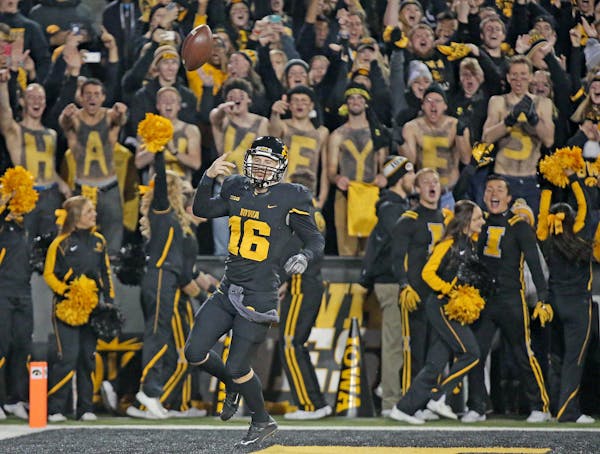 Iowa quarterback C.J. Beathard flipped the ball in the air after running it in for a touchdown in the second quarter