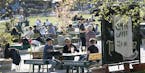 People gather for a drink at an outdoor bar in Stockholm, Sweden, Wednesday April 22, 2020 despite the coronavirus COVID-19 outbreak. (Anders Wiklund/