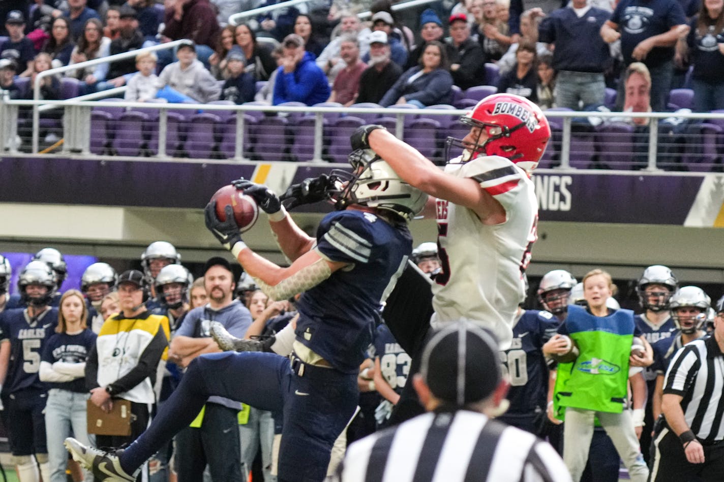 Eden Valley-Watkins wide receiver Landon Neiman (4) caught a pass despite being closely guarded by Cannon Falls Talan Duden (25) in the first half of the Cannon Falls vs Eden Valley-Watkins Class 2A football state semifinals Friday, Nov. 17, 2023 Minneapolis, Minn. . ] GLEN STUBBE • glen.stubbe@startribune.com