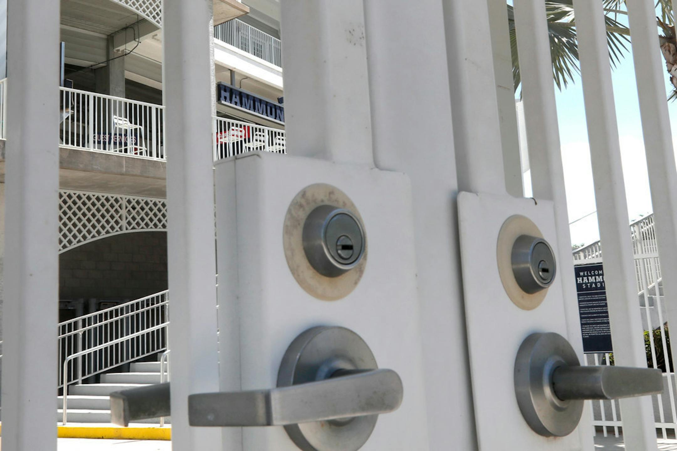 Gates are locked at Minnesota Twins' Hammond Stadium, Monday, March 16, 2020, in Fort Myers, Fla. Major League Baseball has suspended the rest of its spring training game schedule because of the coronavirus outbreak