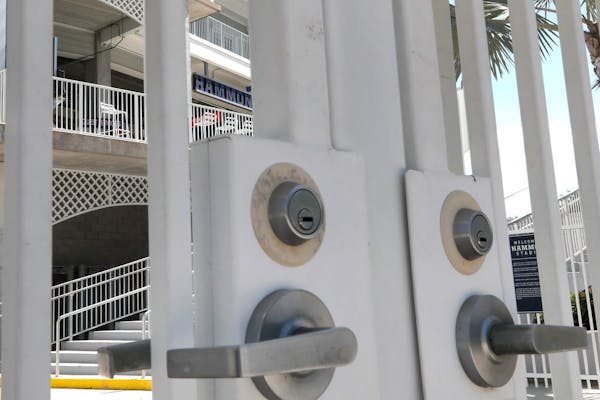 Gates are locked at Minnesota Twins' Hammond Stadium, Monday, March 16, 2020, in Fort Myers, Fla. Major League Baseball has suspended the rest of its 