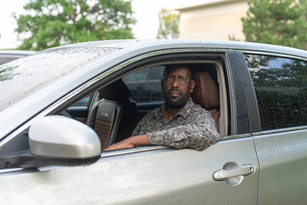 Abddullahi Abd, a member of the Minnesota Uber/Lyft Drivers Association, sits in the vehicle he uses to ferry passengers across the Twin Cities metro 