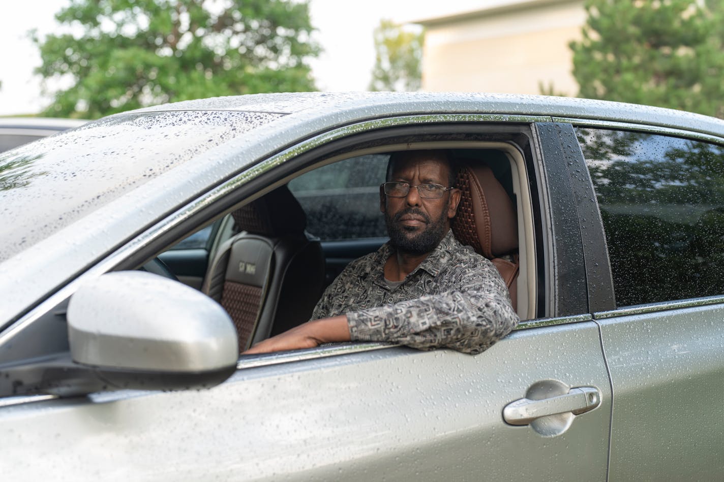 Abddullahi Abd, a member of the Minnesota Uber/Lyft Drivers Association, sits in the vehicle he uses to ferry passengers across the Twin Cities metro area.