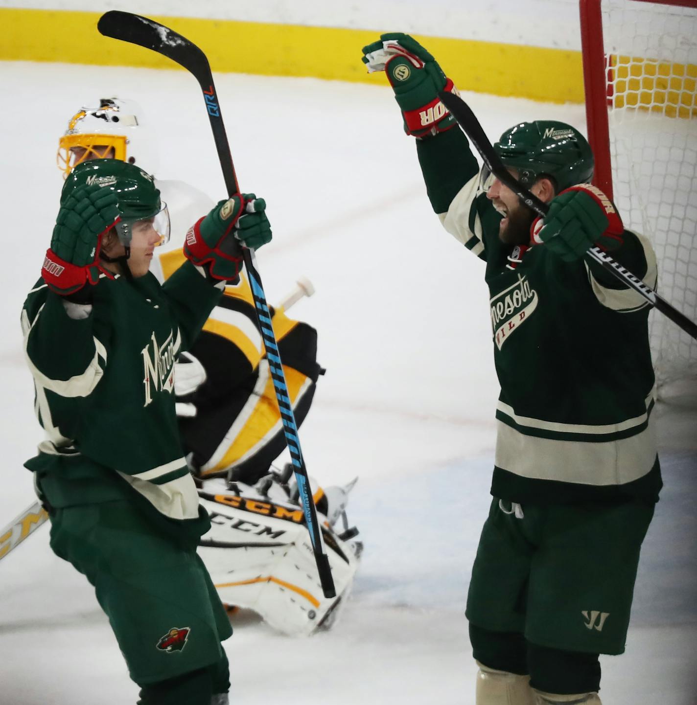 Mikael Granlund(64) and Jason Zucker(16) of the Wild celebrate the fifth goal by Granlund.]In game between the Wild and the Penguins at the Excel Energy Center. Richard Tsong-Taatarii/rtsong-taatarii@startribune