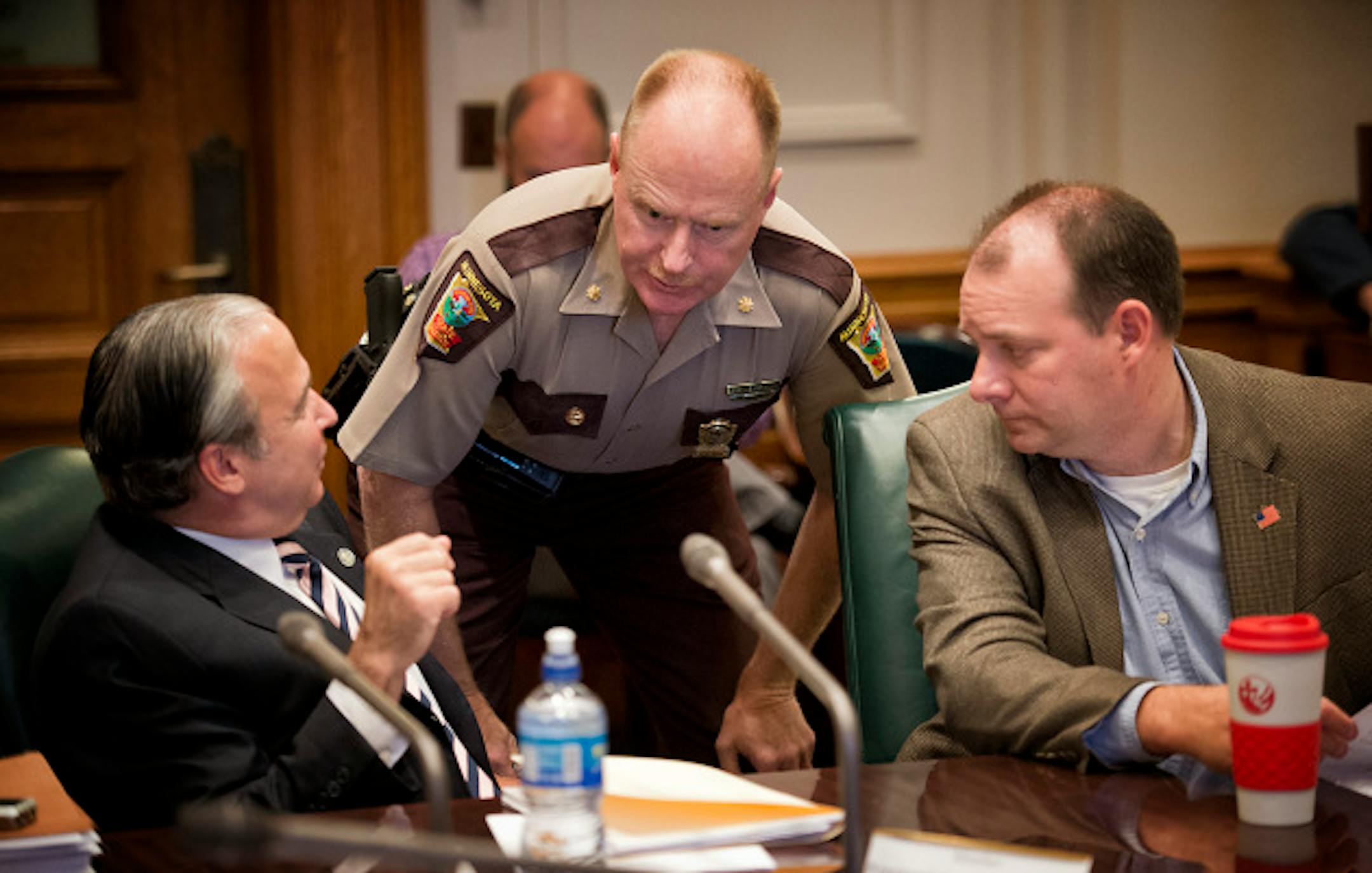 State Patrol Major Bob Meyerson talked with Rep Michael Paymar and Rep. Kelby Woodard before the start of Wednesday's hearing.   An advisory committee on Capitol Security began with two legislators, Rep. Michael Paymar and Sen. Michelle Benson not even knowing if they would be allowed to continue as members of the committee.   Wednesday, August 14, 2013   ]   GLEN STUBBE * gstubbe@startribune.com