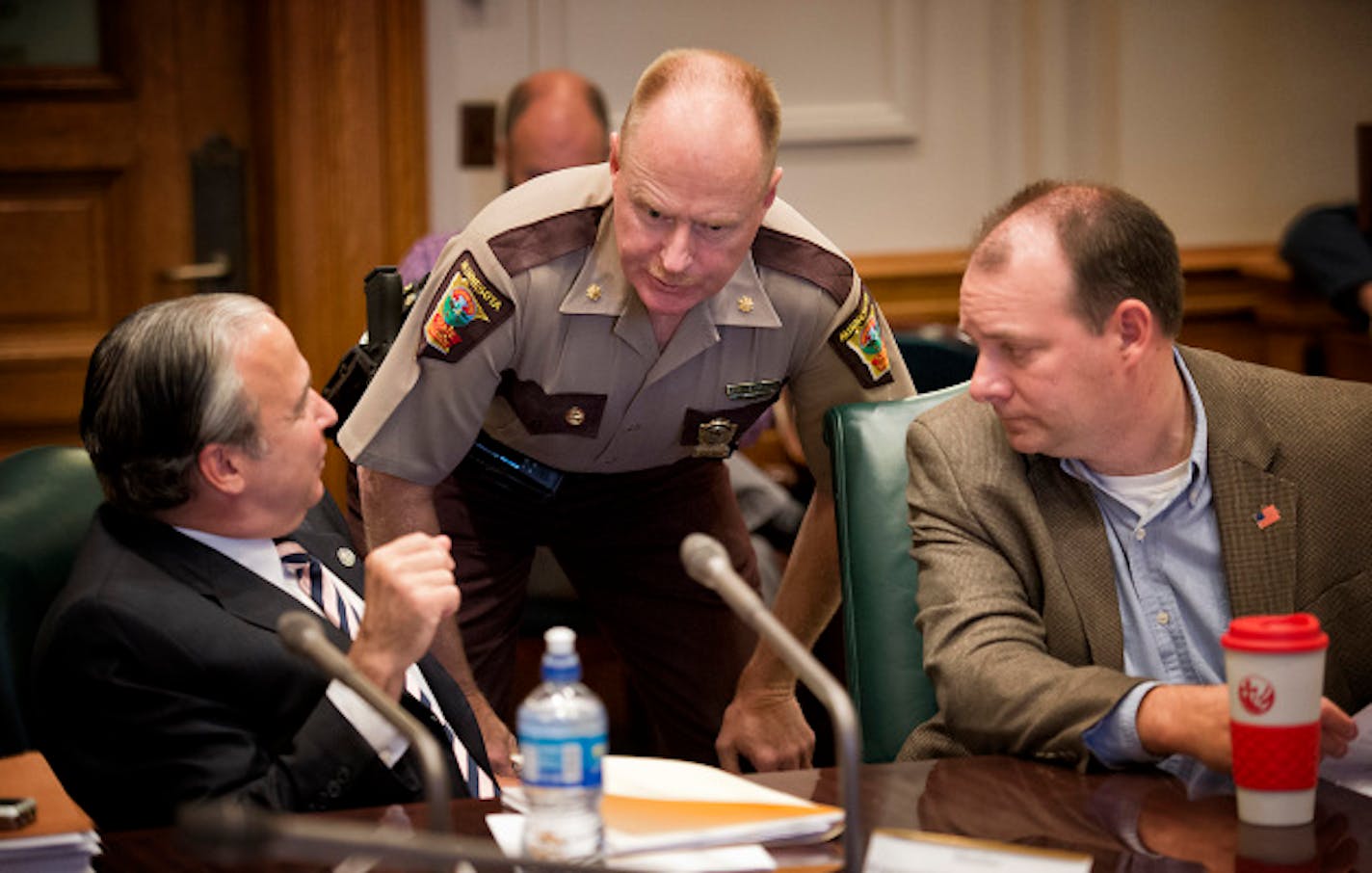 State Patrol Major Bob Meyerson talked with Rep Michael Paymar and Rep. Kelby Woodard before the start of Wednesday's hearing.   An advisory committee on Capitol Security began with two legislators, Rep. Michael Paymar and Sen. Michelle Benson not even knowing if they would be allowed to continue as members of the committee.   Wednesday, August 14, 2013   ]   GLEN STUBBE * gstubbe@startribune.com