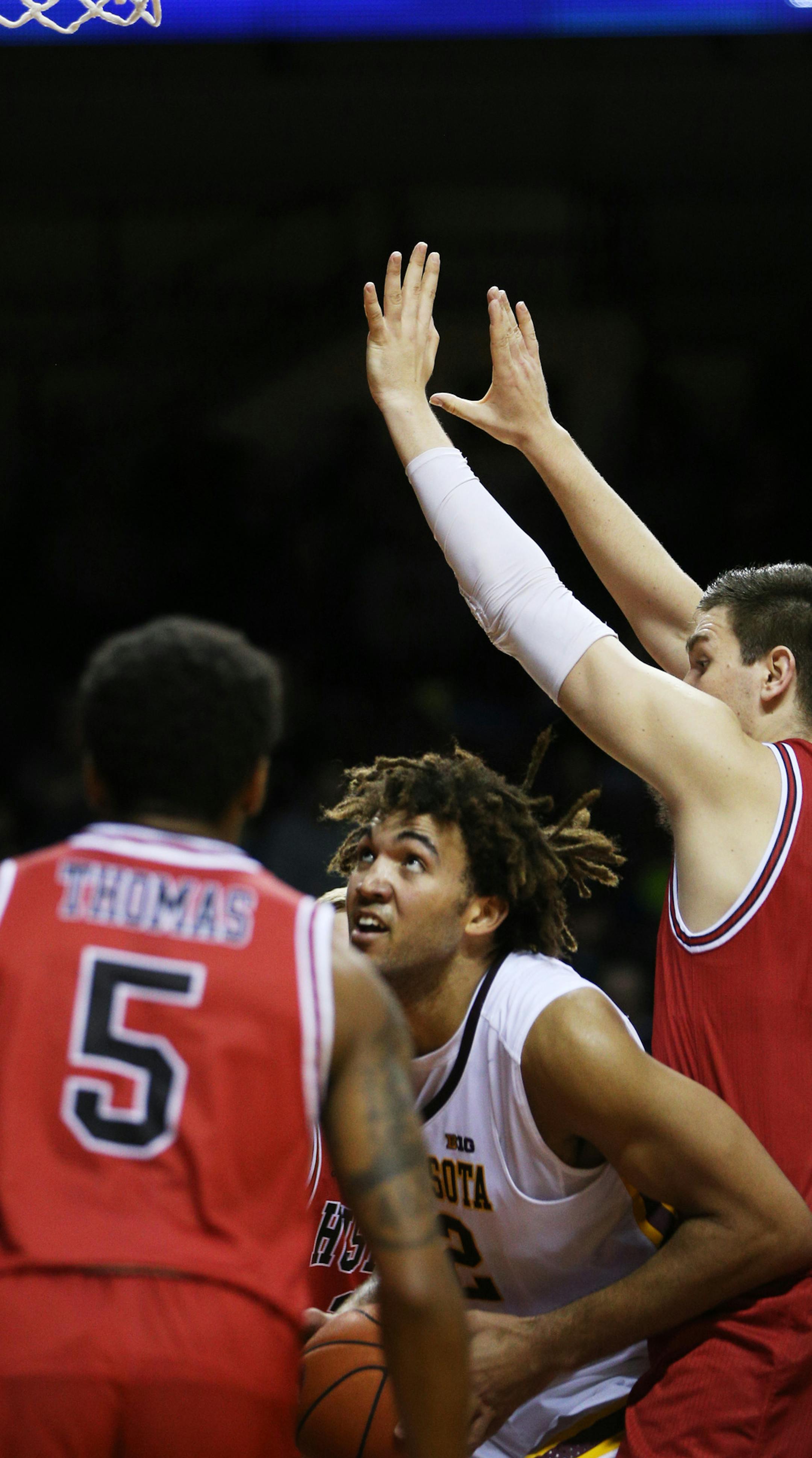 Gophers center Reggie Lynch (22) looked for an opening between Huskies Justin Thomas (5) and Marin Maric (34). ] Mark Vancleave - mark.vancleave@startribune.com * Northern Illinois University Huskies played the University of Minnesota Gophers on Sunday, Dec. 11, 2016 at Williams Arena in Minneapolis.