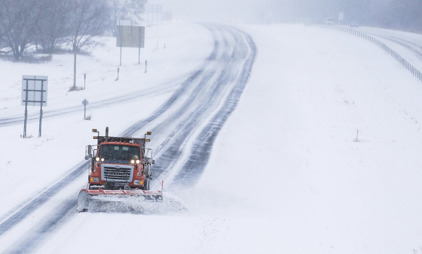 A MnDOT snow plow clears snow on northbound Hwy. 52 at the Marion Road Southeast exit Saturday, Dec. 1, 2018, south of Rochester, Minn. (Andrew Link/The Rochester Post-Bulletin via AP)