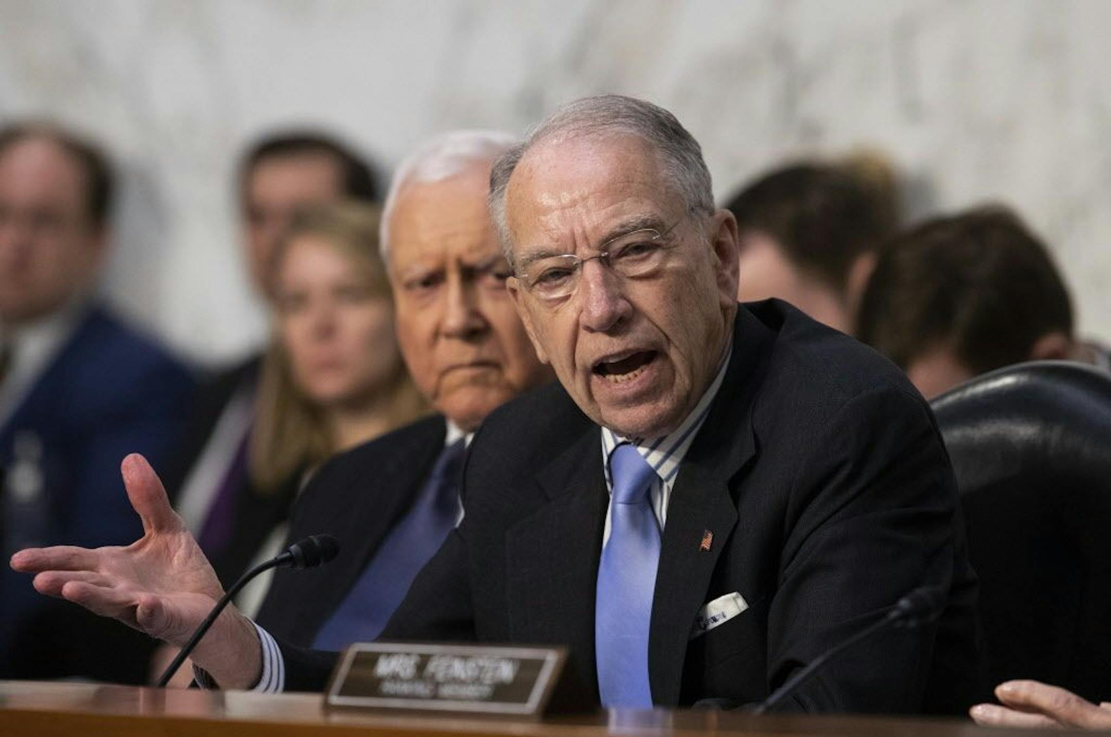 Senate Judiciary Committee Chairman Chuck Grassley, R-Iowa, joined at left by Sen. Orrin Hatch, R-Utah, deals with objections from Democratic members of the panel as Supreme Court nominee Brett Kavanaugh waits to testify before on the third day of his confirmation hearing, on Capitol Hill in Washington, Thursday, Sept. 6, 2018.