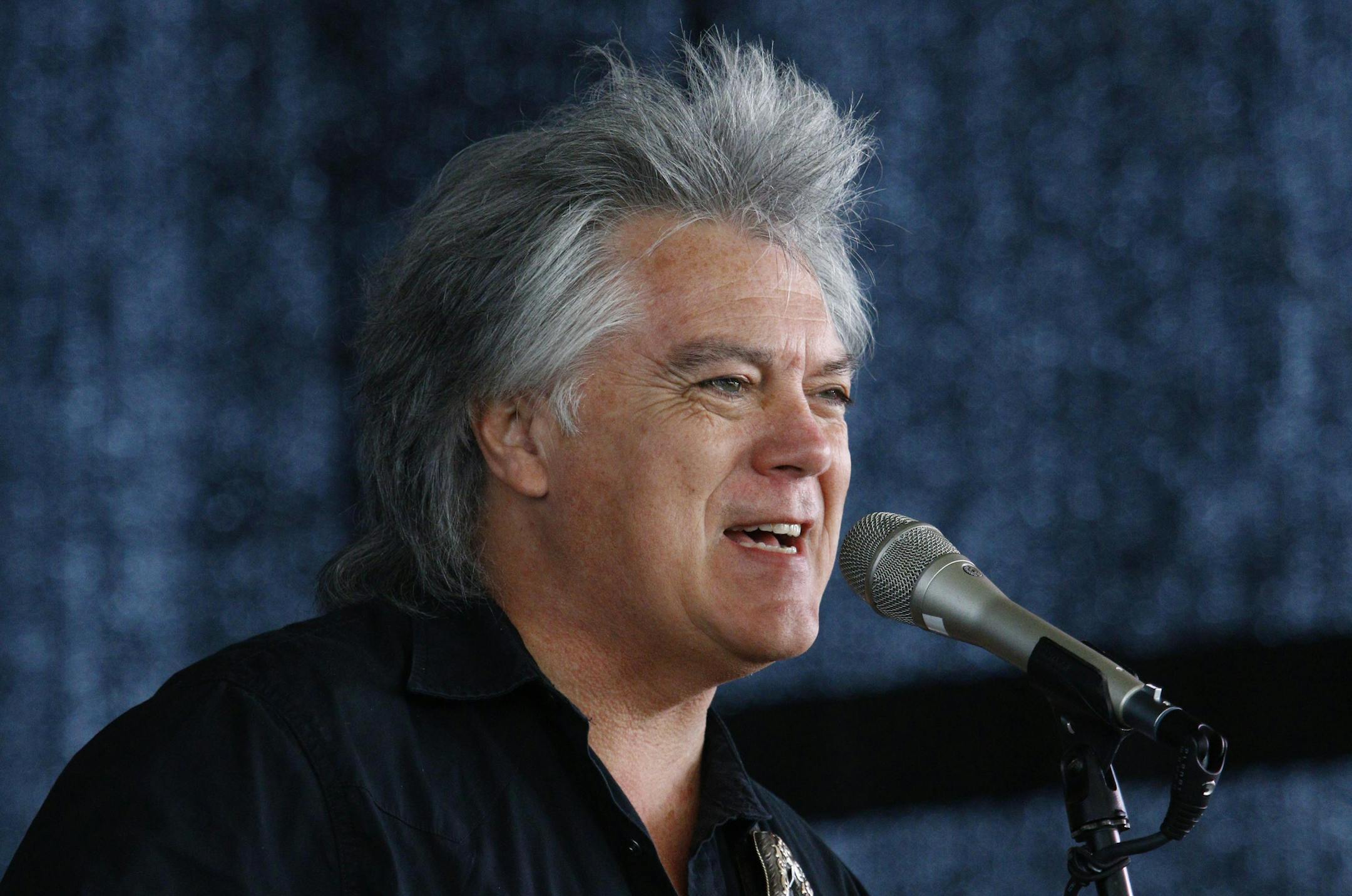 Country music star Marty Stuart sings during a mike check prior to his band's performance at a First Responders Remembrance salute, Friday, Aug. 28, 2015, in Gulfport, Miss., in recognition of the 10th anniversary of Hurricane Katrina. Former President George W. Bush will join former Mississippi Gov. Haley Barbour, current Gov. Phil Bryant and other lawmakers in honoring the first responders with a concert and lunch. (AP Photo/Rogelio V. Solis)