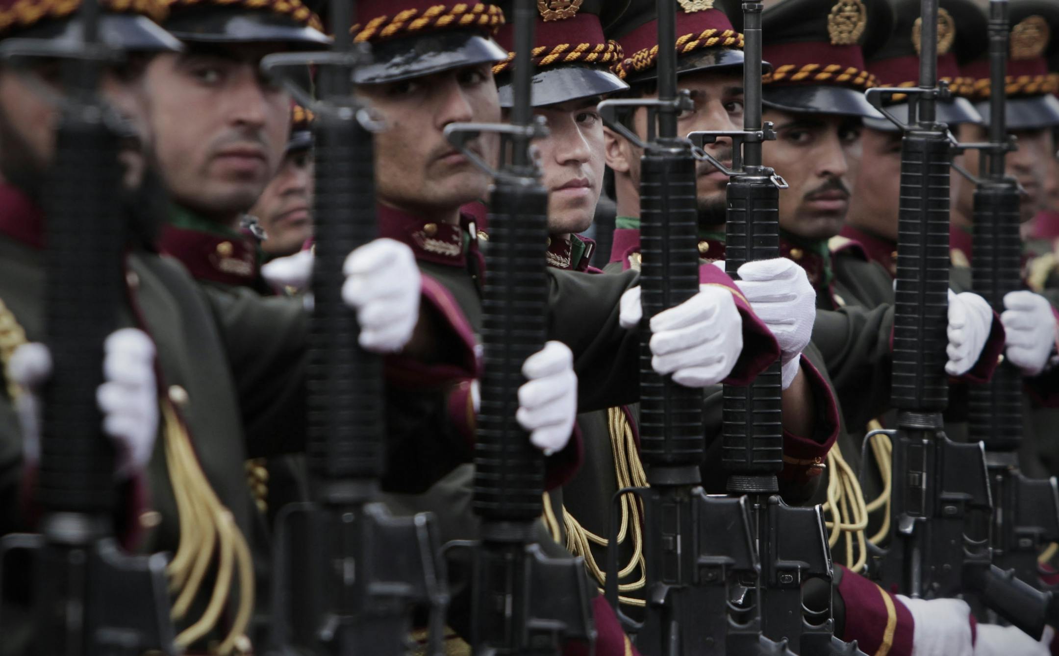 Afghan honor police stand to attention during the third phase of a transfer of an authority ceremony from the NATO- led troops to Afghan security forces in Kunar province, east of Kabul, Afghanistan, Oct. 10, 2012.