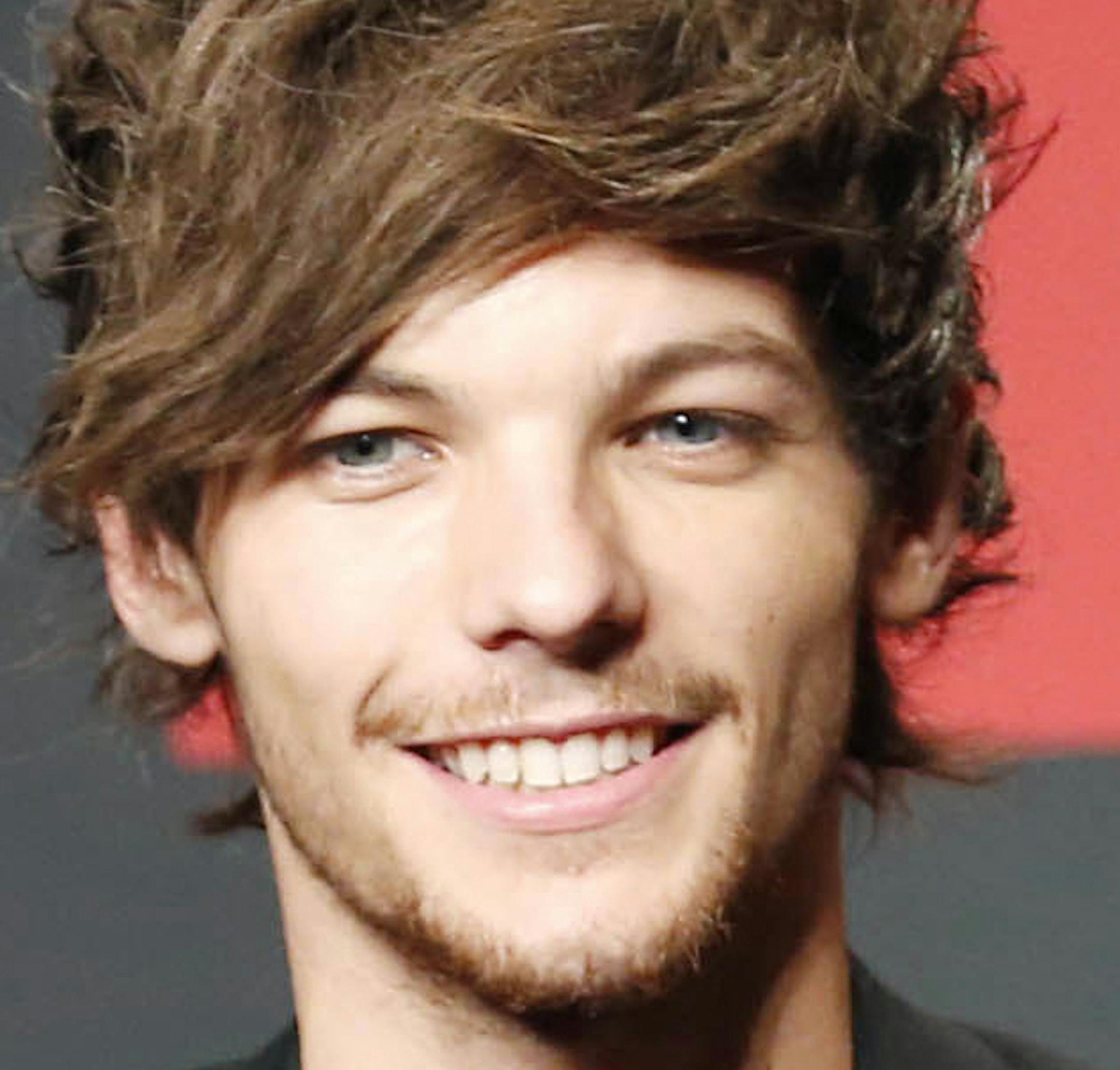 FILE - This Nov. 3, 2013 file photo shows One Direction members Louis Tomlinson, left, and Zayn Malik during an event for their film "One Direction: This Is US," in Makuhari, near Tokyo. One Direction fans have reacted with dismay to a report that band member Louis Tomlinson is to become a father. Publicist Simon Jones declined to comment Wednesday, July 15, 2015 on a People magazine report saying 23-year-old Tomlinson is expecting a child with American stylist Briana Jungwirth. (AP Photo/Koji S