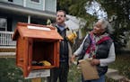 Todd Bol helped Eddye Watkins erect a Little Free Library on her yard in Minneapolis in October 2013.
