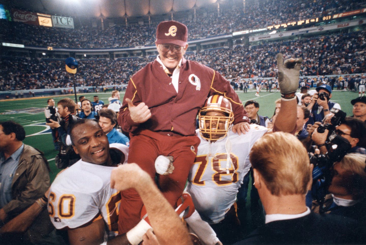 Members of the Washington Redskins pro football team carried coach Joe Gibbs off the Metrodome (Minneapolis) field after the 1992 Super Bowl.