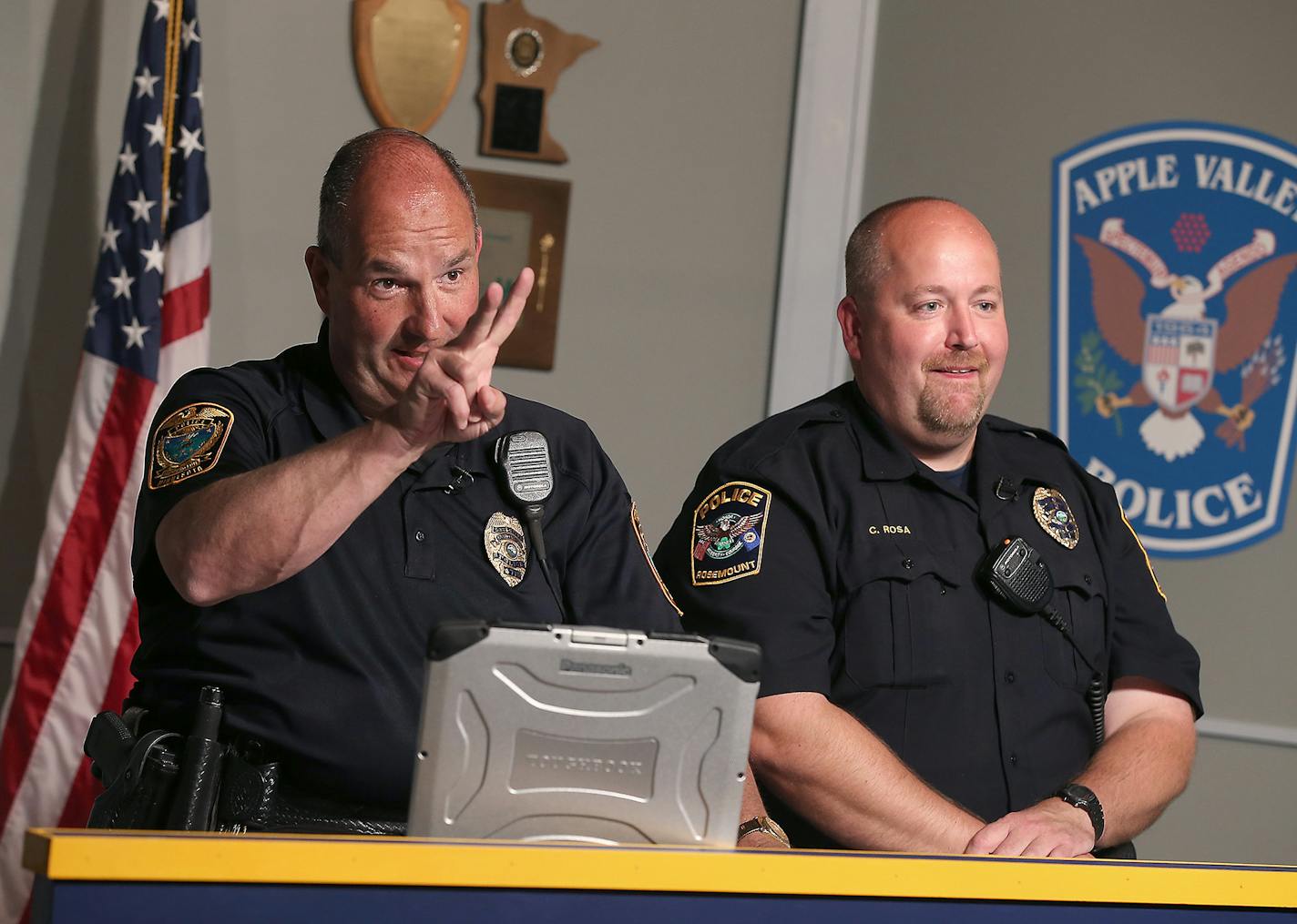 Farmington Police officer Steve Kuyper, left, and Rosemount Police officer Chad Rosa, worked on taping a police informational show, Wednesday, July 22, 2015 in Apple Valley, MN.