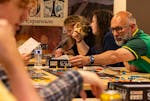 Christopher Brooks moves a piece on the Arcs board game during a game night at Leder Games in St. Paul, Minn., on Wednesday, July 24, 2024.