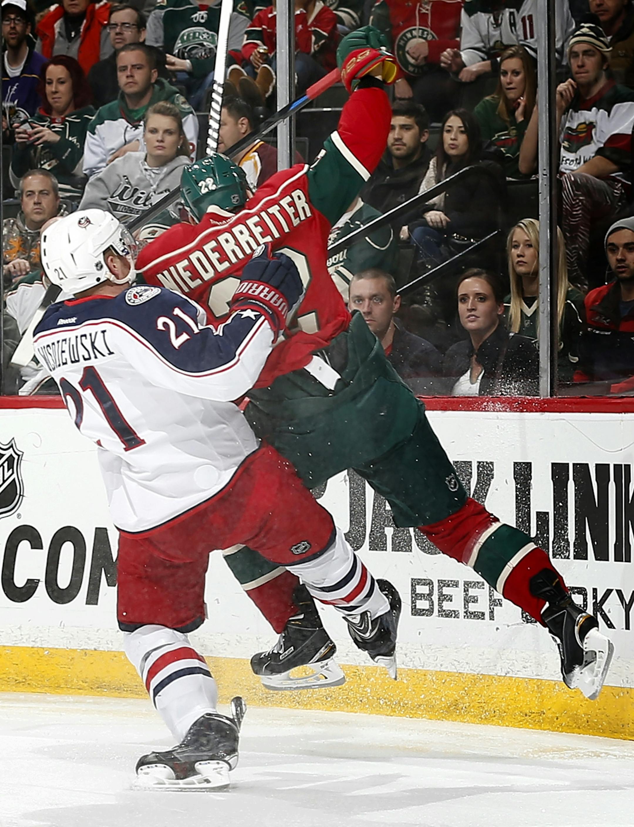 James Wisniewski (21) and Nino Niederreiter (22) collided in the first period.