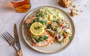 A traditional Irish meal for St. Patrick's Day: Salmon, Colcannon, mixed cabbage and carrots, and soda bread.