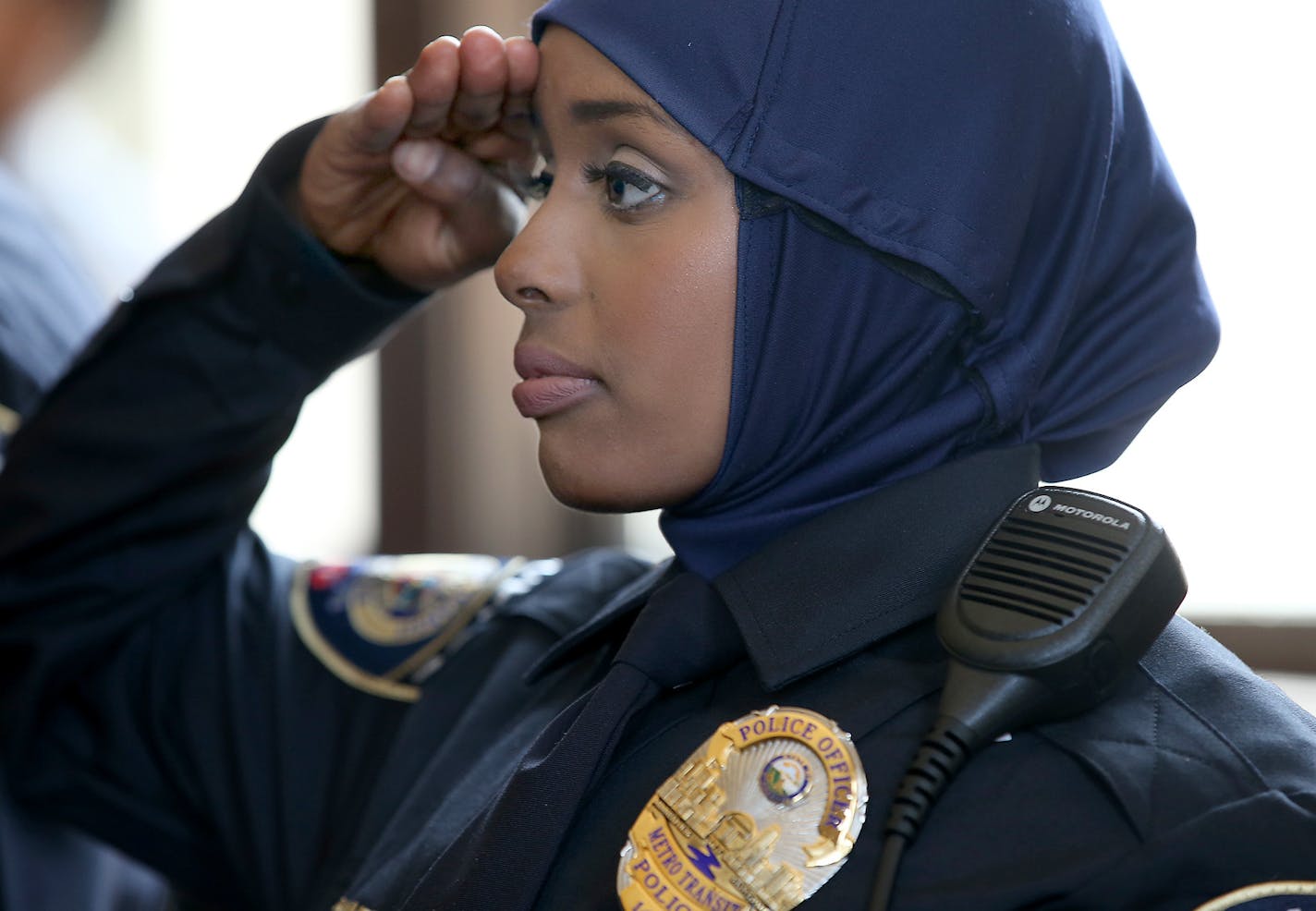 Kara Mohamed saluted the American flag during a swearing-in ceremony at the Union Depot, Thursday, April 20, 2015 in St. Paul, MN. ] (ELIZABETH FLORES/STAR TRIBUNE) ELIZABETH FLORES &#x2022; eflores@startribune.com