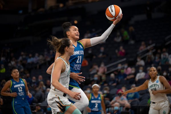 Minnesota Lynx guard Kayla McBride (21) shot while outrunning the defense of New York Liberty guard Rebecca Allen (9) in the first quarter.