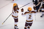 Gophers forward Jimmy Snuggerud (81) celebrated a goal with defenseman Jackson LaCombe in a Nov. 4 home victory vs. Notre Dame.
