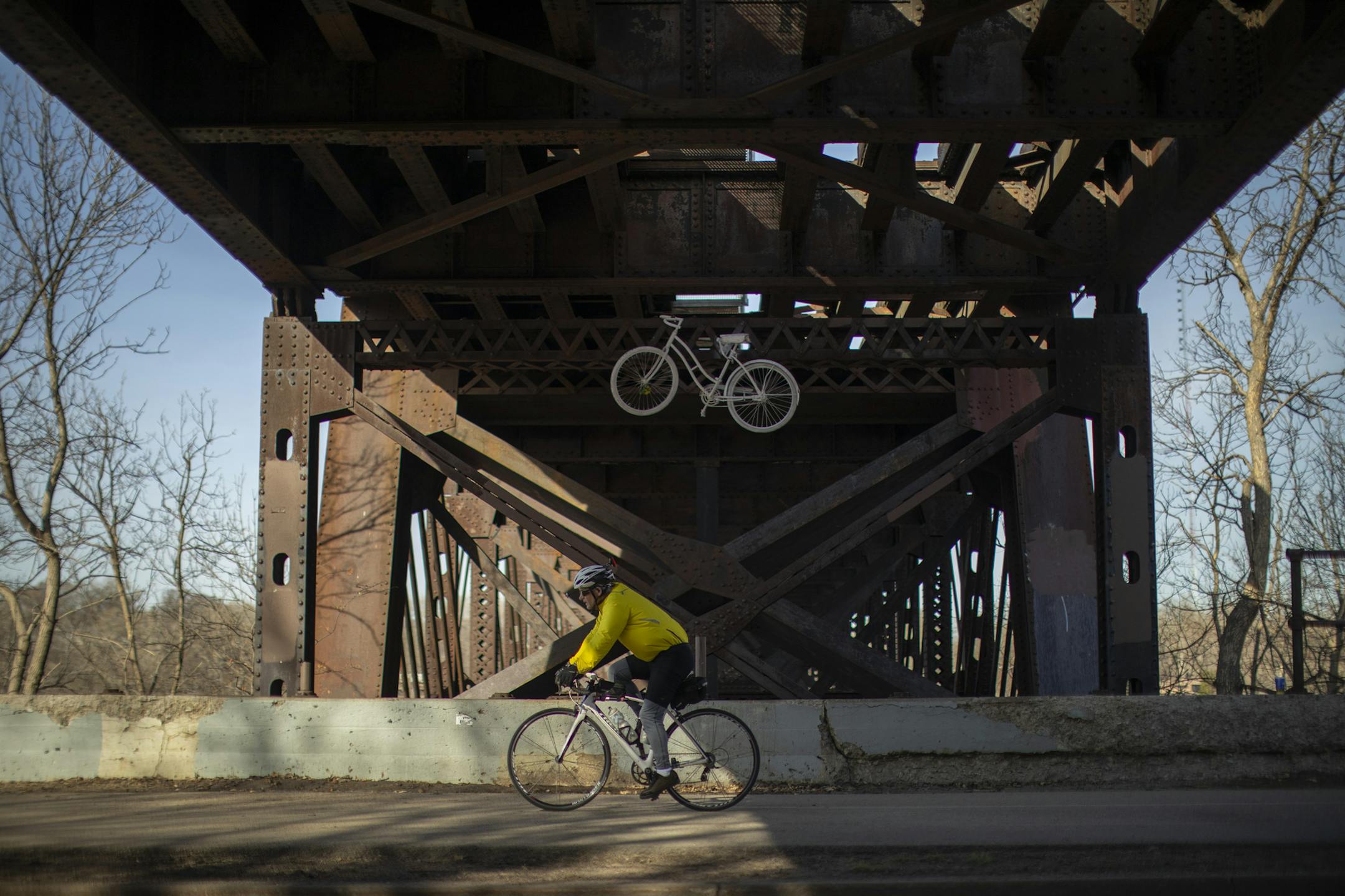 A cyclist on the West River Parkway bike path rode beneath the Short Line bridge Wednesday afternoon. ] JEFF WHEELER ï jeff.wheeler@startribune.com There are discussions taking place about exploring whether the CM & StP Railroad's Short Line bridge over the Mississippi River at the Midtown Greenway could be overhauled for bike and pedestrian use. The Greenway / railroad corridor was photographed Wednesday afternoon, April 25, 2018 in Minneapolis.