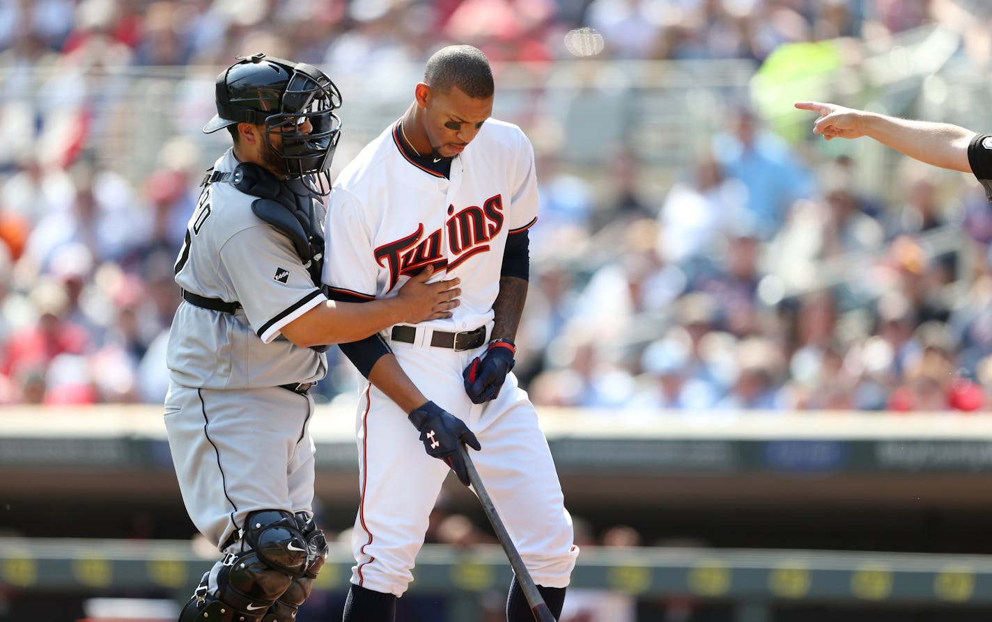 White Sox catcher Dioner Navarro assisted Minnesota Twins center fielder Byron Buxton (25) after he was hit by a pitch thrown by Mat Latos in the third inning at Target Field Thursday April 14, 2016 in Minneapolis, MN.