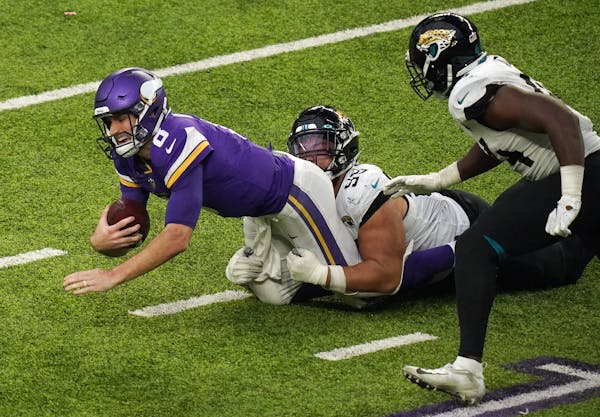 Minnesota Vikings quarterback Kirk Cousins (8) was sacked by Jacksonville Jaguars defensive tackle Rodney Gunter (99) in the fourth quarter. ] ANTHONY