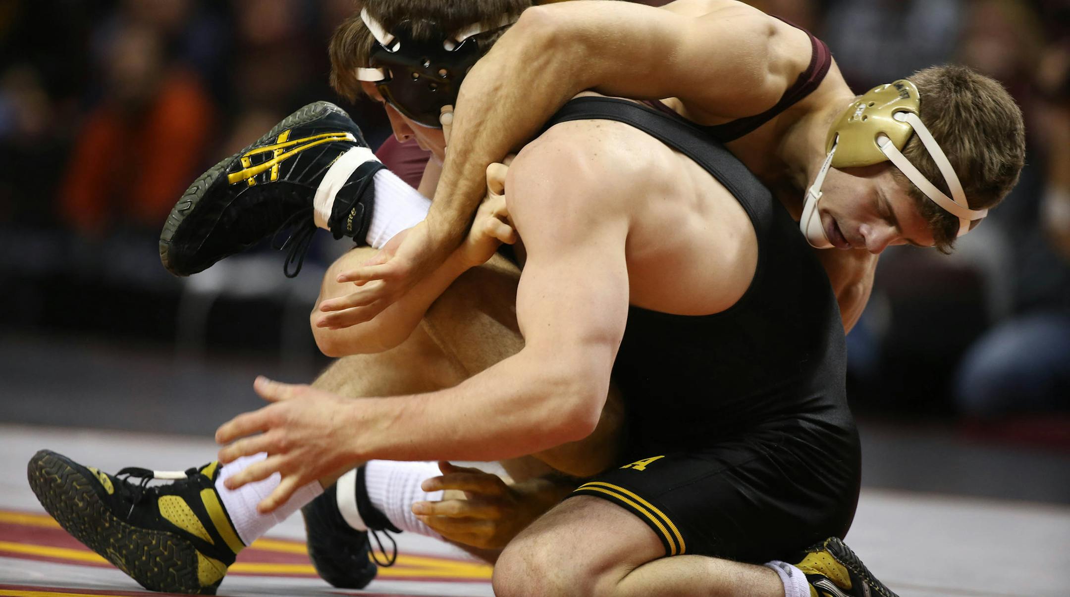 Gopher Dylan Ness and Iowa's Michael Kelly wrestled for control in the 157 weight class. ] (KYNDELL HARKNESS/STAR TRIBUNE) kyndell.harkness@startribune.com Gophers vs Iowa wrestling meet at Williams Arena inMinneapolis Min., Friday, January 30, 2015. Iowa won over Minnesota 23-12.