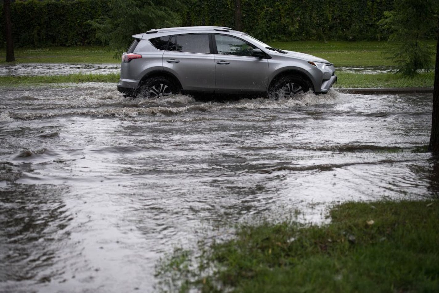 A motorist drove through flash flooding along Dunwoody Boulevard near Lyndale Avenue South on Tuesday in Minneapolis.