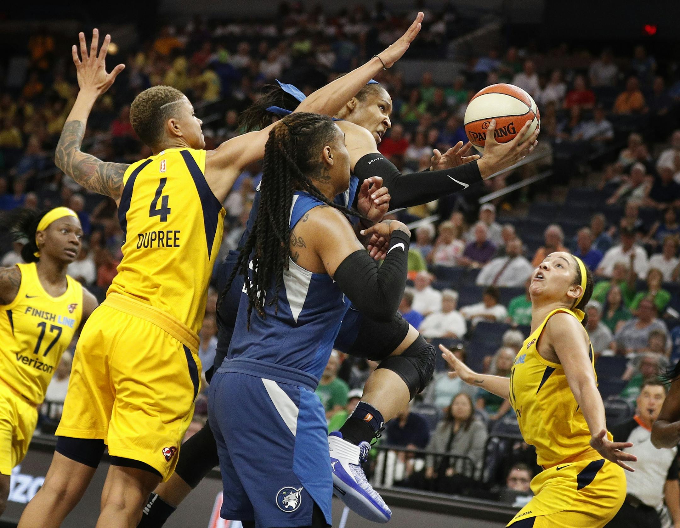 Lynx Maya Moore split the Fever defense for a basket at Target Center Wednesday July 18, 2018 in Minneapolis , MN.
