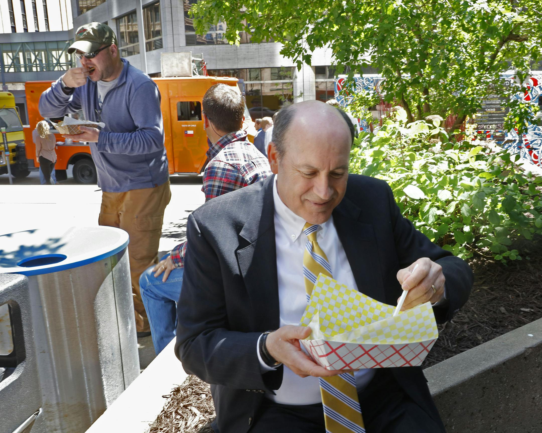 Brian Avery, who works for Wells Fargo, had a taco from one of the food trucks while sitting amid flower beds outside the Canadian Pacific building.