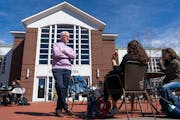 Rosenberg chatted with international studies junior Amalia Chiapperino and psychology junior Lilli Kay as they worked outside on campus. ] MARK VANCLE