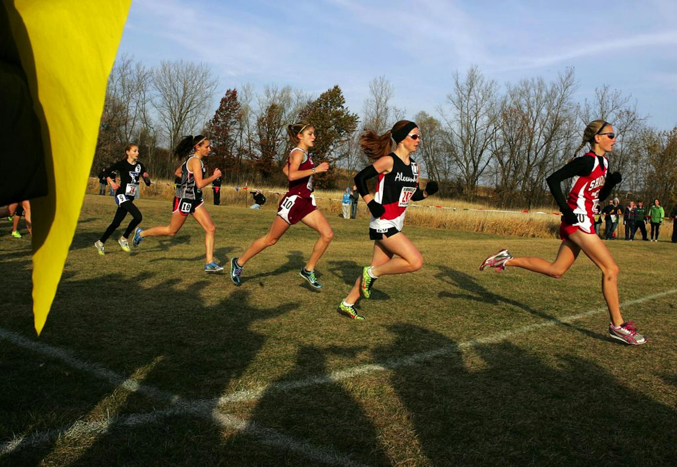 Shakopee's Maria Hauger, right, leads early in the Class AA girls' 4000-meter race, followed by Alexandria's Jamie Piepenburg, second from right, at the Minnesota State High School Cross Country Championships at St. Olaf College in Northfield November 4, 2011. Hauger pushed forward at the end of the race to take first, beating Piepenburg by mere strides.