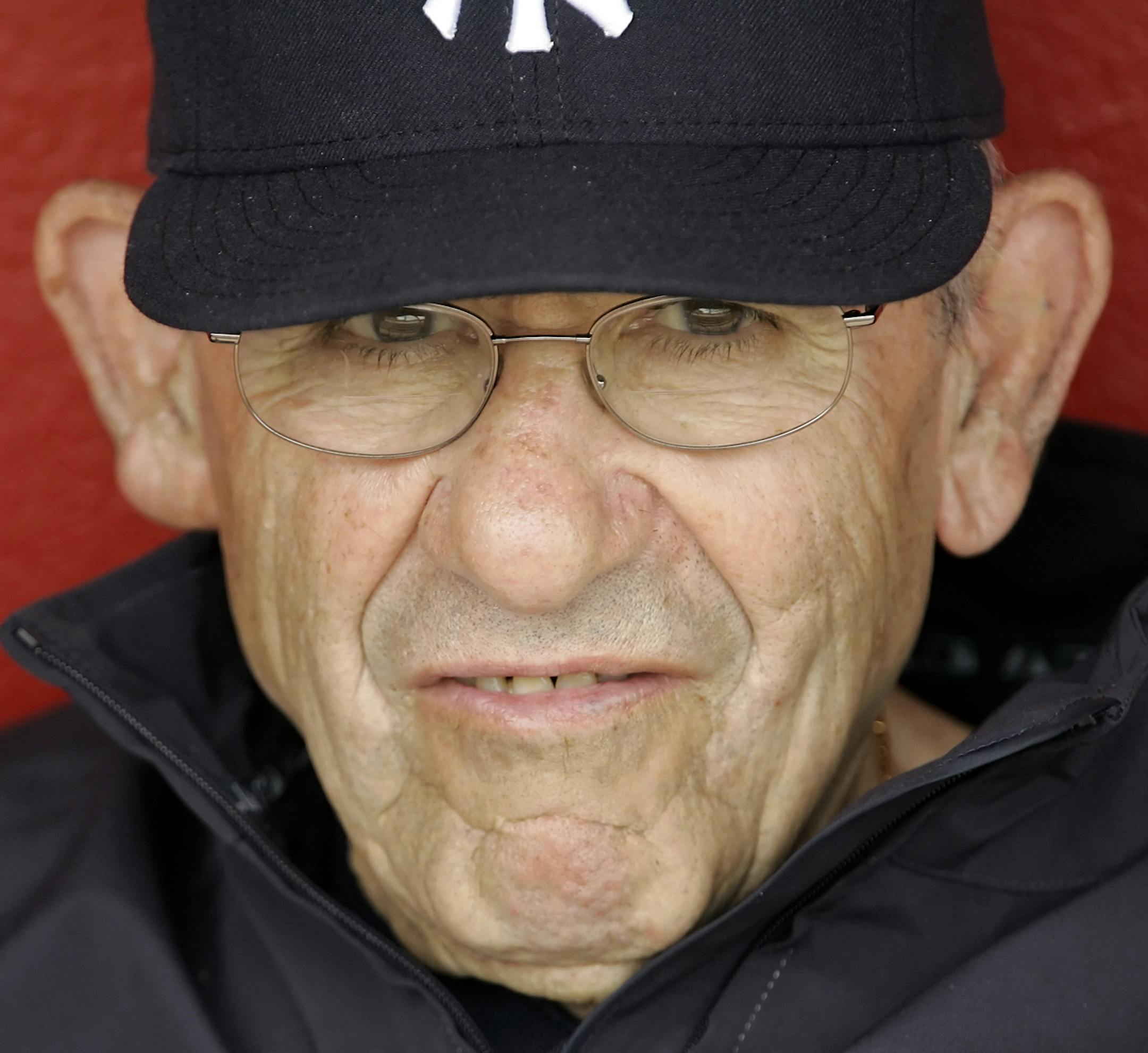 FILE - In this March 6, 2008, file photo, New York Yankees hall of fame catcher Yogi Berra watches spring training baseball action against the Cincinnati Reds in Sarasota, Fla. The Hall of Fame catcher renowned as much for his lovable, linguistically dizzying "Yogi-isms" as his unmatched 10 World Series championships with the Yankees, died Tuesday, Sept. 22, 2015. He was 90. (AP Photo/Gene J. Puskar, File)
