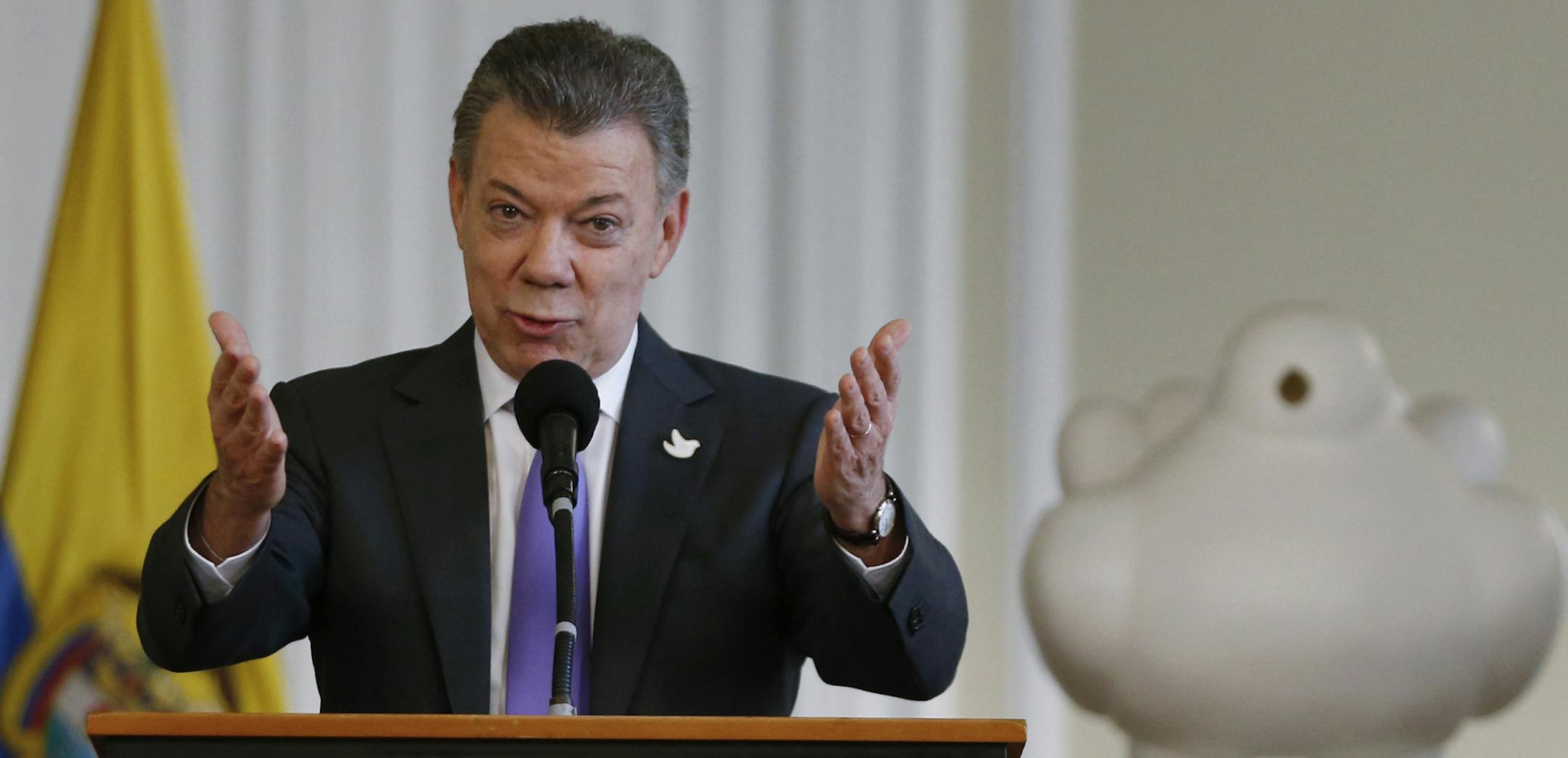 Colombia's President Juan Manuel Santos speaks to supporters of the peace deal he signed with rebels of the Revolutionary Armed Forces of Colombia, FARC, at the presidential palace in Bogota, Colombia, Friday, Oct. 7, 2016, behind a sculpture of a white dove donated by Colombian artist Fernando Botero. Santos won the Nobel Peace Prize Friday, just days after voters narrowly rejected a peace deal. (AP Photo/Fernando Vergara) ORG XMIT: MIN2016100713003534