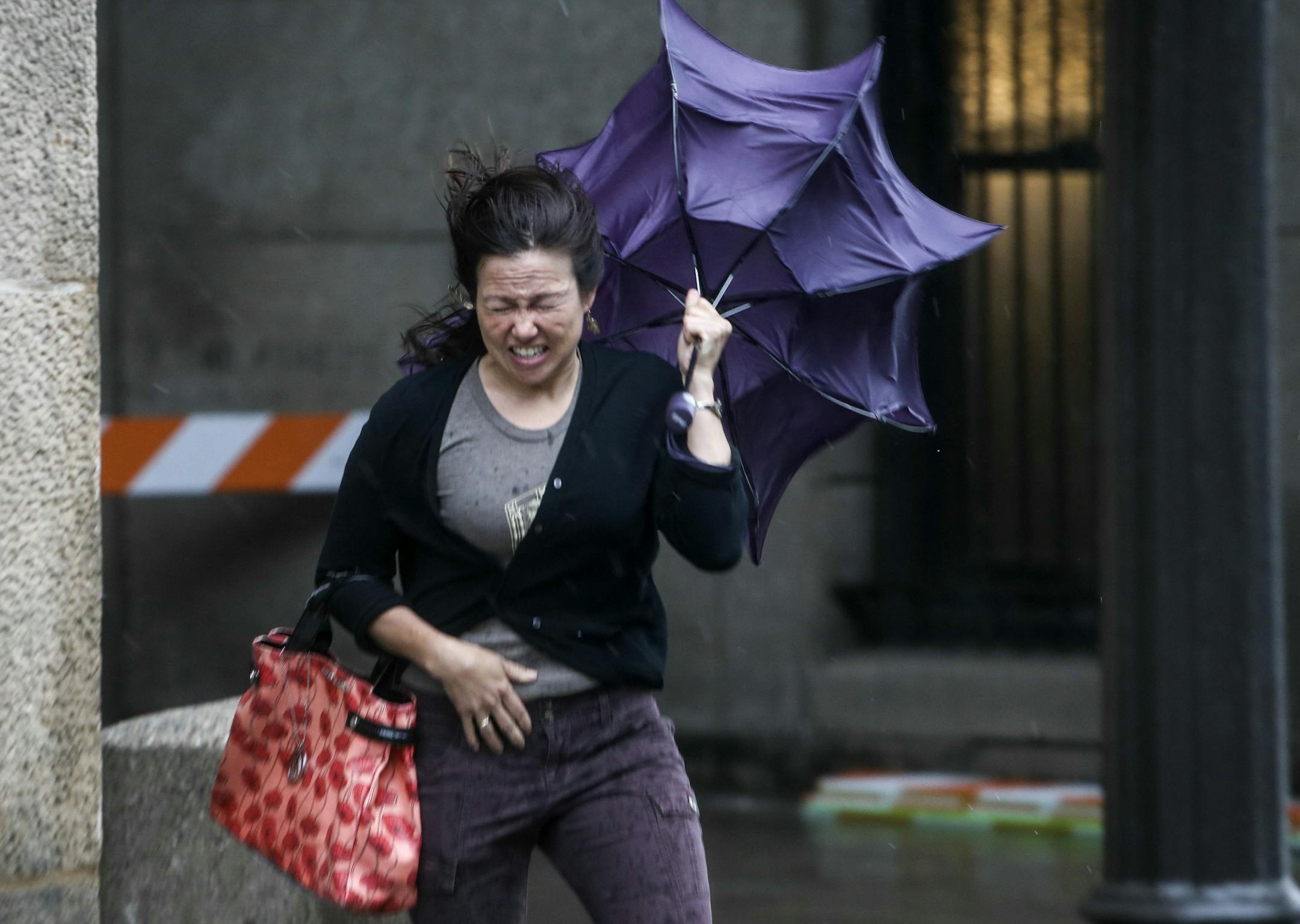 Coming from train opening ceremonies at Union Station April Amys of St. Paul fights gail force winds while making her way Saturday, June 14, 2014, in St. Paul, MN. Amys said the weather was greatly effecting business describing the winds as "pretty trecherous."