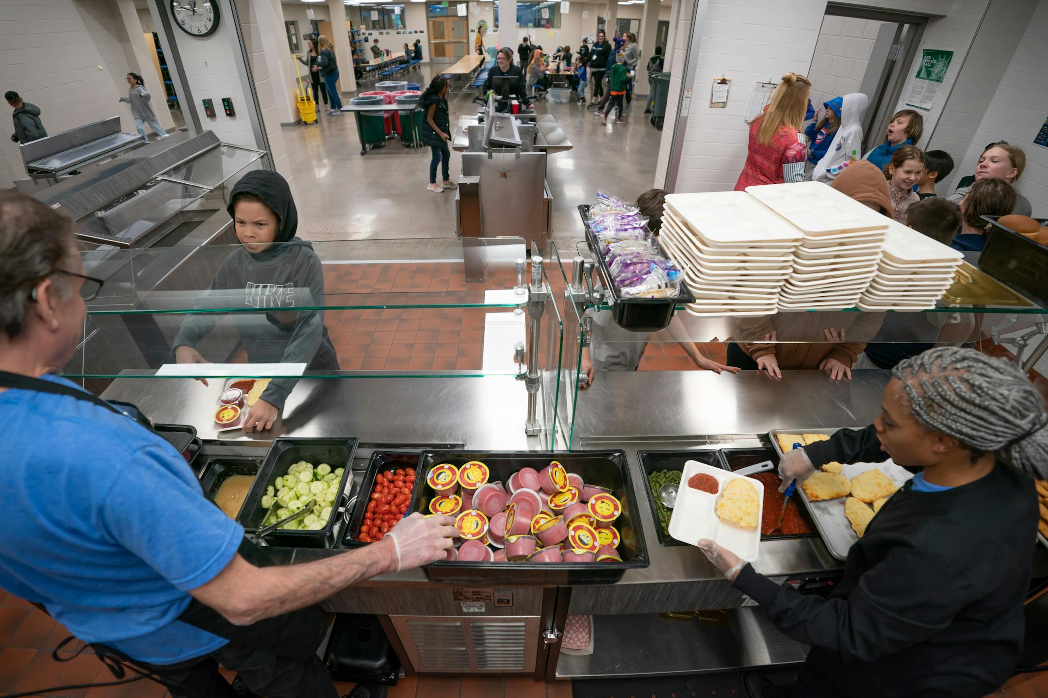 Jeff Skarsten and Cassandra Day served school lunch to 5th graders at Champlin-Brooklyn Park Academy on Friday, Feb. 17, 2023 in Champlin, Minn.