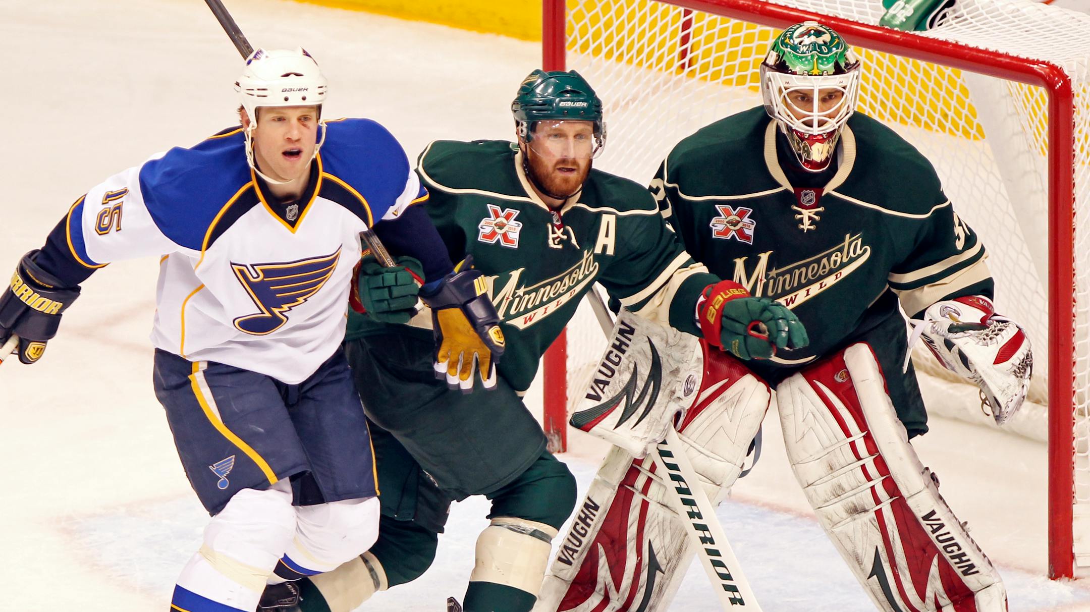 St. Louis' Brad Winchester (15) jockeys for position with the Wild's Greg Zanon, middle, and goal tender Niklas Backstrom during second period action in 2011. Winchester was traded to Minnesota on Feb. 26, 2014.