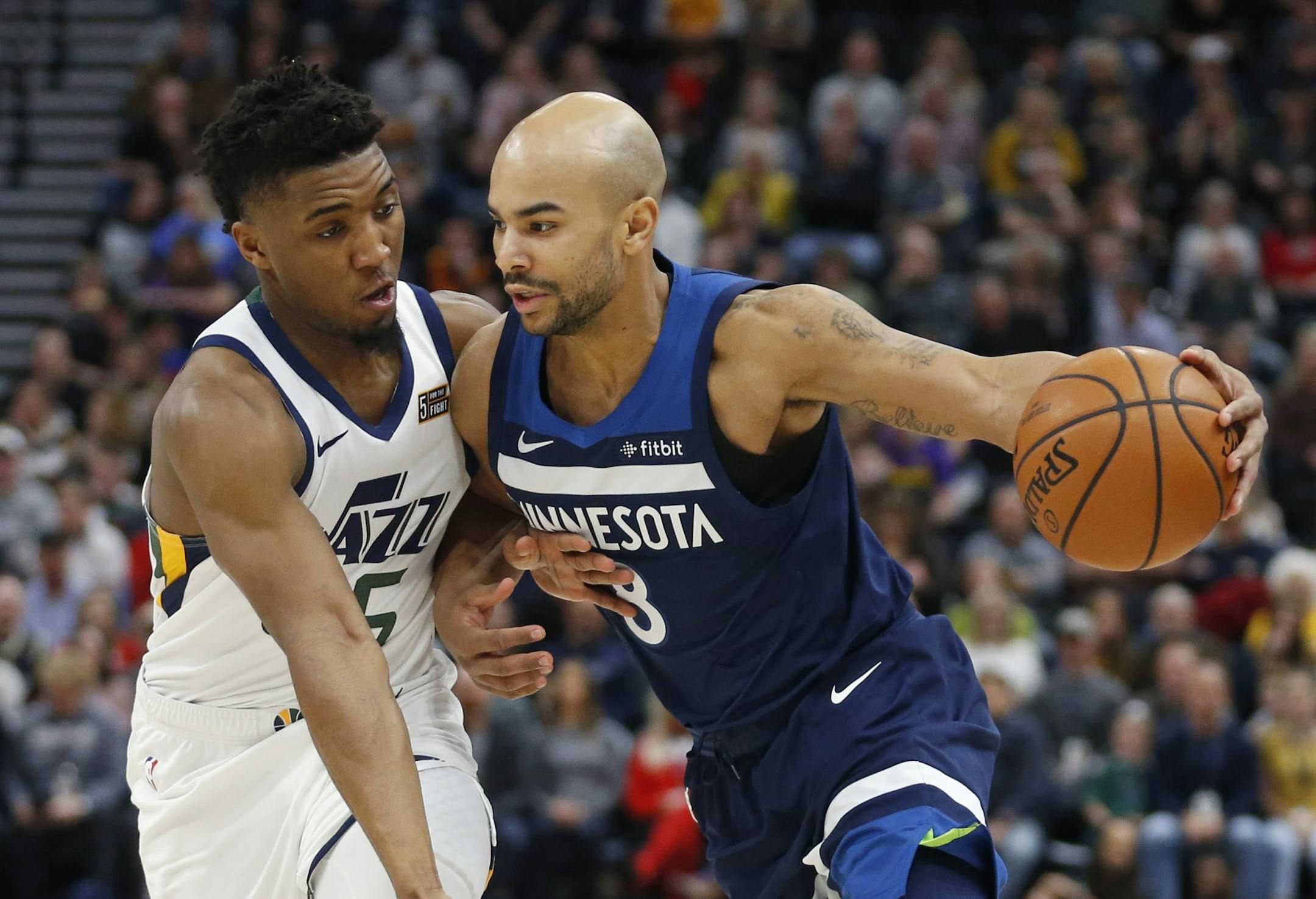 Minnesota Timberwolves guard Jerryd Bayless (8) drives against Utah Jazz guard Donovan Mitchell (45) during the first half of an NBA basketball game Friday, Jan. 25, 2019, in Salt Lake City.
